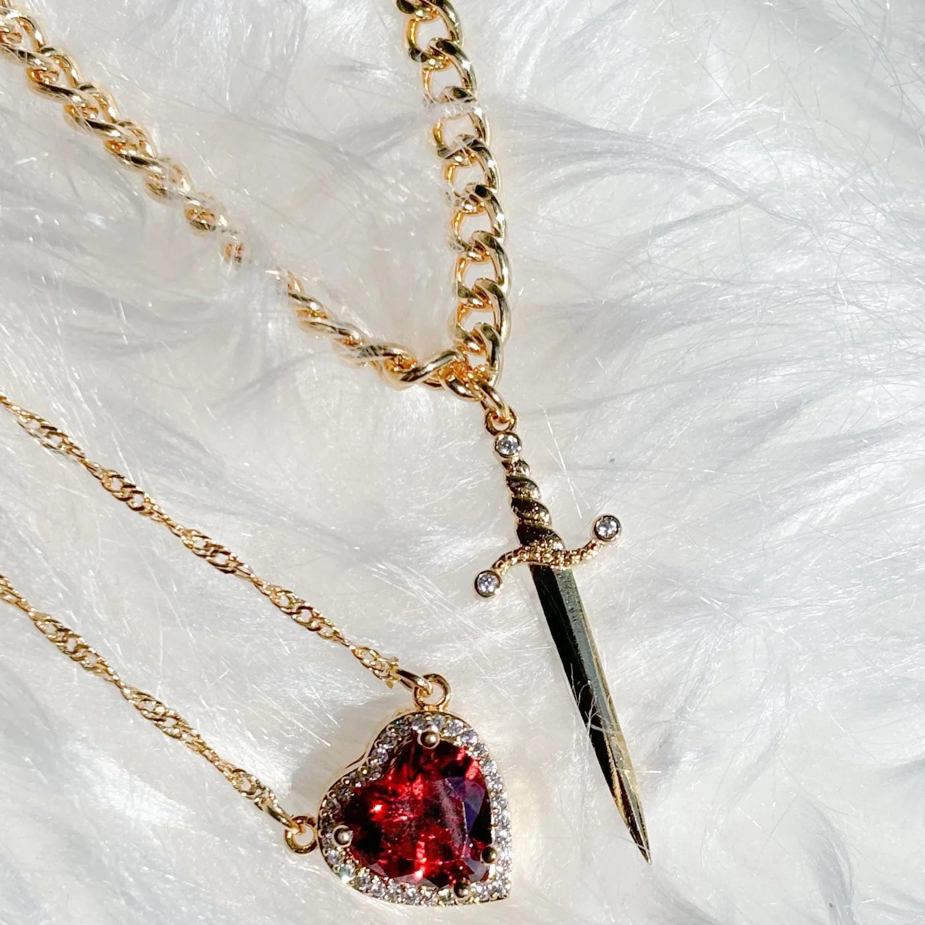 Side-by-side view of both components of the necklace: Sword and Heart.